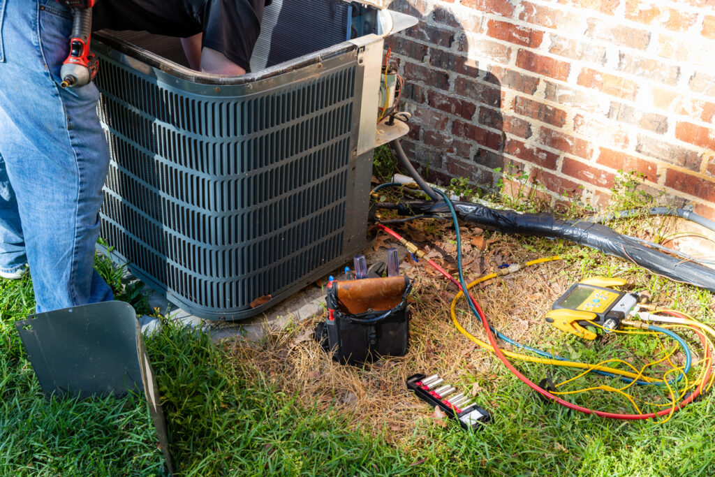 Air conditioner maintenance being performed