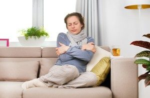 woman in house is cold and needs boiler replacement services