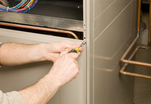 furnace repair being done by technician