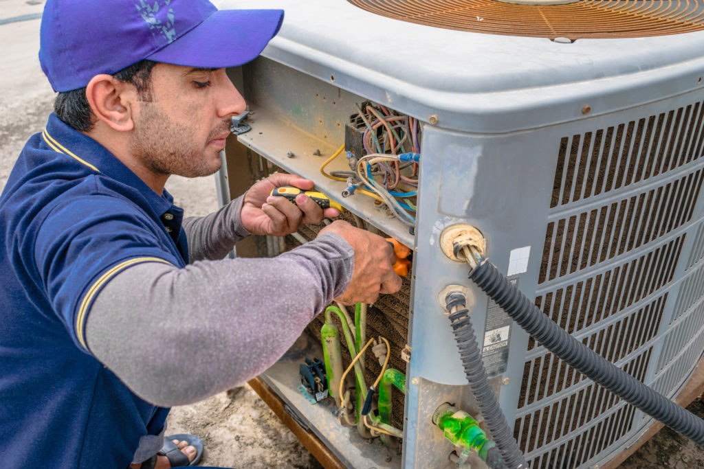 hvac contractor fixing an HVAC system