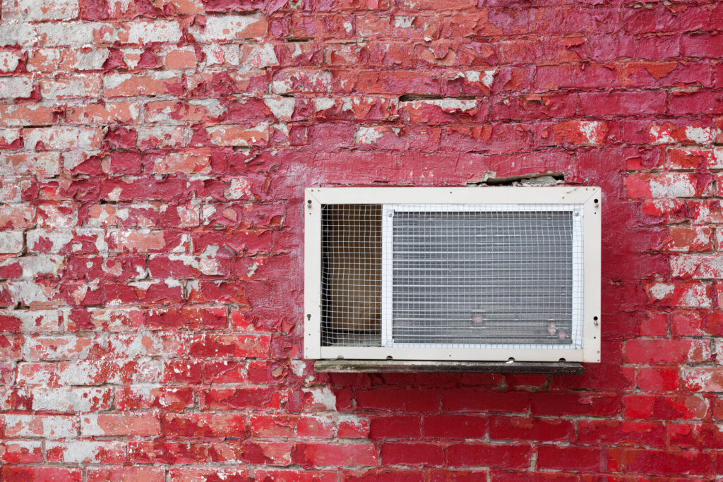 ductless system mounted into a red brick wall in Macon